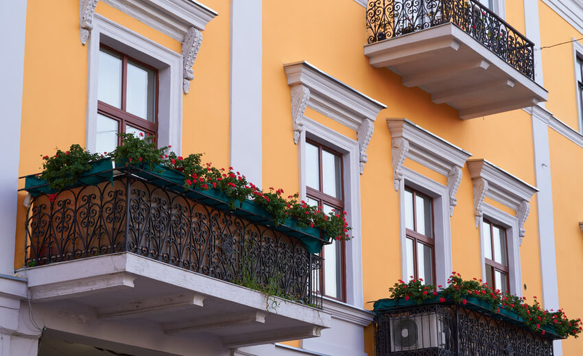 yellow wall balcony decorated flowers